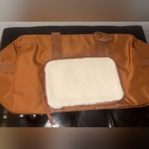 Brown and white duffle bag